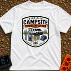 Campsite Crisis Wrangler - T-Shirt in White - A badge-style illustration of a white camper van parked among pine trees,...