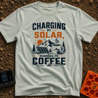 Solar Powered Coffee Fueled - T-Shirt in Bay - A graphic illustration featuring a portable solar panel and a large...