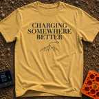 Charging Somewhere Better - T-Shirt in Mustard - Text reading "CHARGING SOMEWHERE BETTER" stacked above a minimalist line...