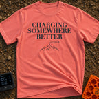 Charging Somewhere Better - T-Shirt in Watermelon - Text reading "CHARGING SOMEWHERE BETTER" stacked above a minimalist...