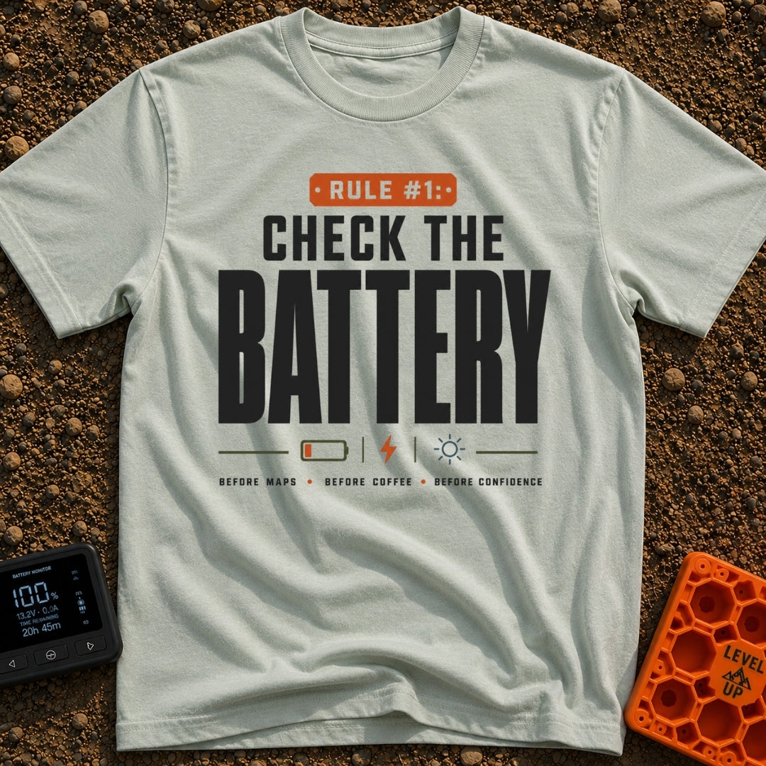Battery Before Coffee - T-Shirt in Bay - Typographic design featuring bold text reading "RULE #1: CHECK THE BATTERY"...