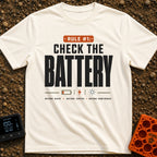 Battery Before Coffee - T-Shirt in Ivory - Typographic design featuring bold text reading "RULE #1: CHECK THE BATTERY"...