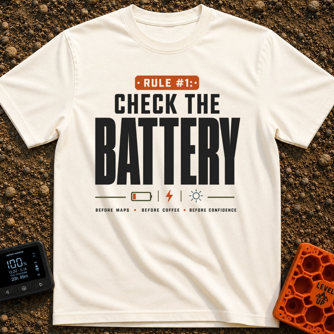 Battery Before Coffee - T-Shirt in Ivory - Typographic design featuring bold text reading "RULE #1: CHECK THE BATTERY"...