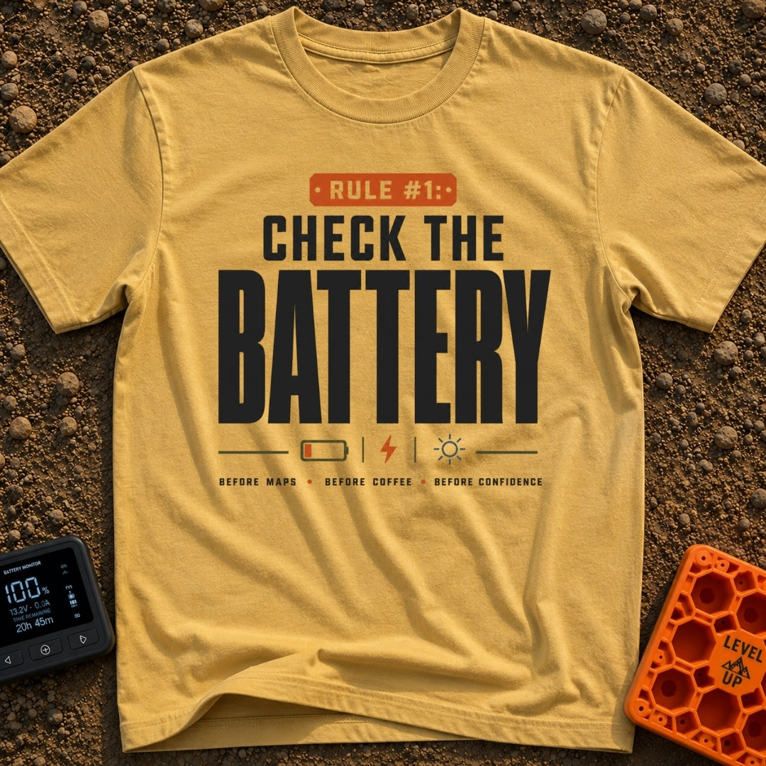 Battery Before Coffee - T-Shirt in Mustard - Typographic design featuring bold text reading "RULE #1: CHECK THE BATTERY"...