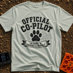 Director of Snacks - T-Shirt in Bay - A black and white graphic featuring a large animal paw print centered between...