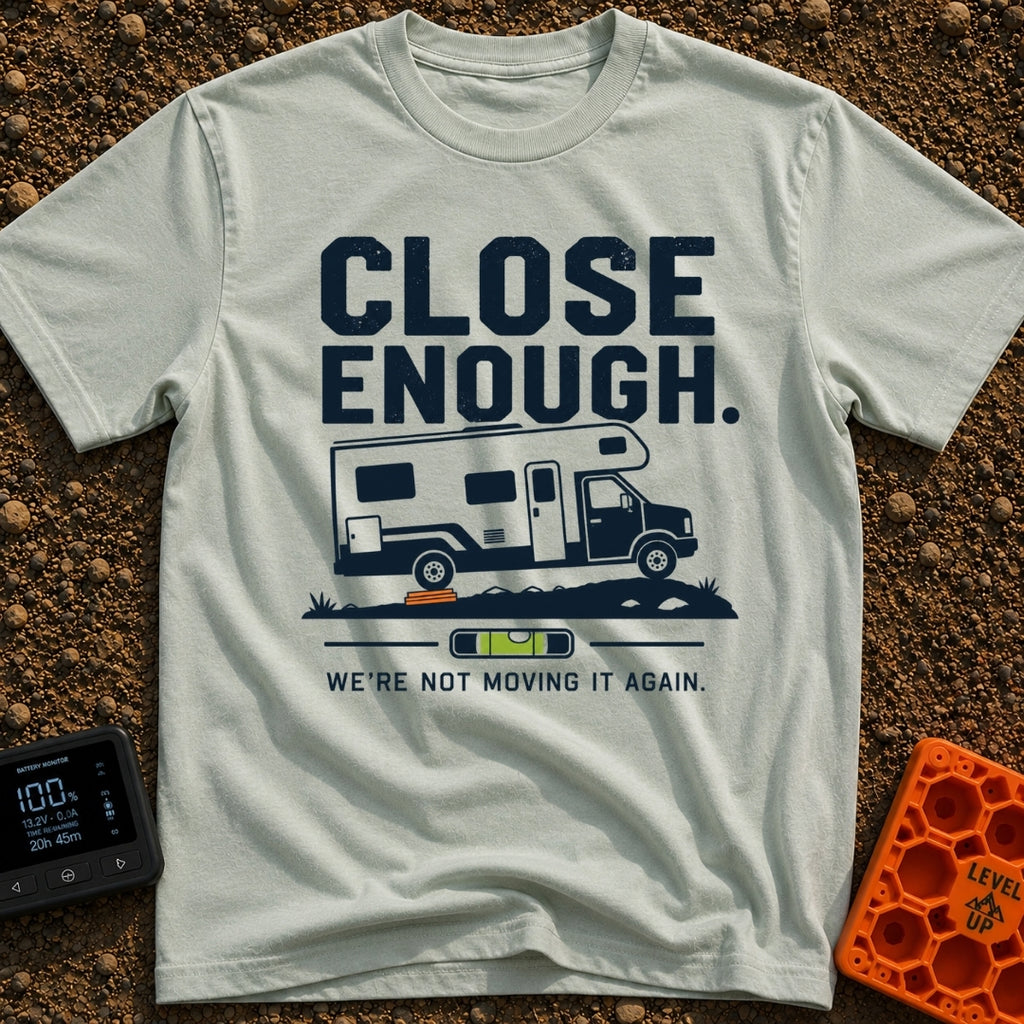 Not Moving It Again - T-Shirt in Bay - A graphic design featuring a Class C motorhome parked on uneven ground with orange...