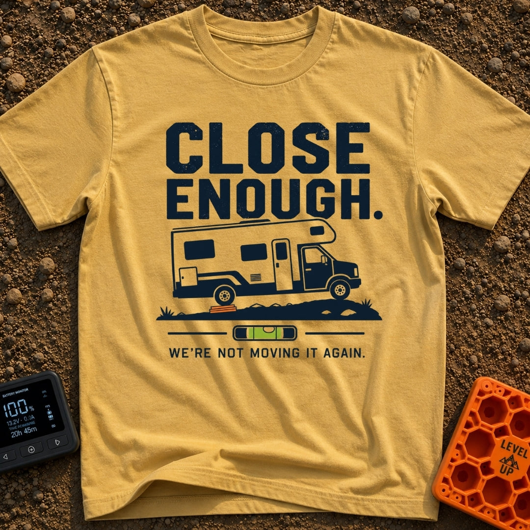 Not Moving It Again - T-Shirt in Mustard - A graphic design featuring a Class C motorhome parked on uneven ground with...
