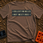 Miles Over Meetings - T-Shirt in Espresso - A graphic of a retro black and yellow split-flap display board showing the...