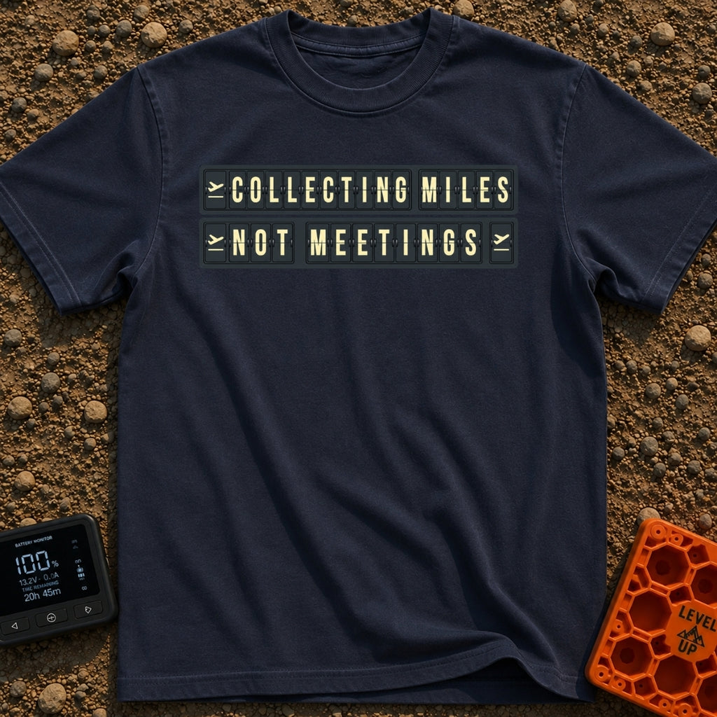 Miles Over Meetings - T-Shirt in Navy - A graphic of a retro black and yellow split-flap display board showing the phrase...