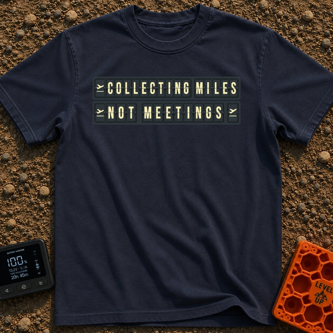 Miles Over Meetings - T-Shirt in Navy - A graphic of a retro black and yellow split-flap display board showing the phrase...