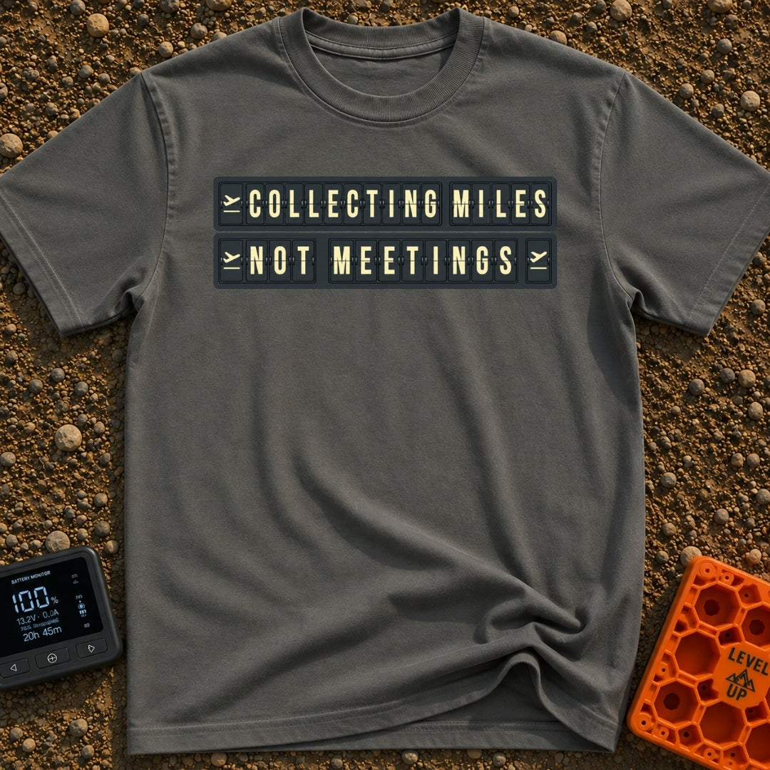 Miles Over Meetings - T-Shirt in Pepper - A graphic of a retro black and yellow split-flap display board showing the...