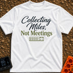 Miles Over Meetings - T-Shirt in White - Text reading "Collecting Miles, Not Meetings" displayed above a simple line...