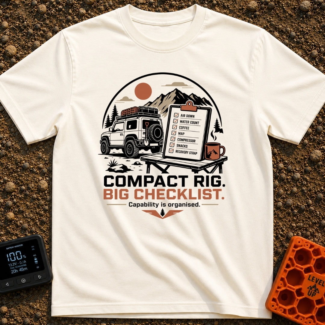 Tiny Rig Big Checklist - T-Shirt in Ivory - A small 4x4 vehicle with a roof rack and off-road gear parked in front of...