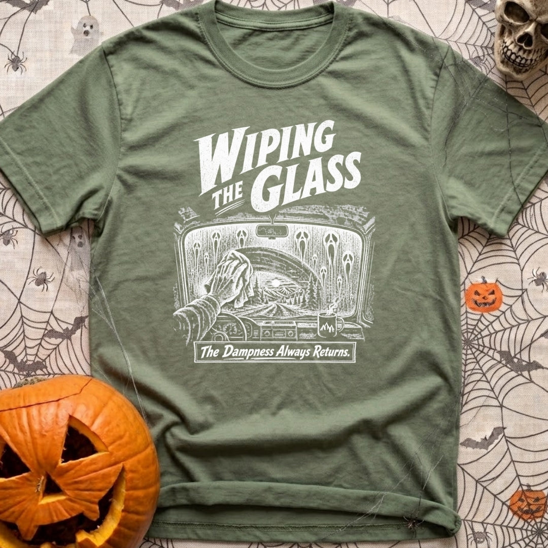 Dew Or Die - T-Shirt in Moss - A white line drawing from the perspective of a vehicle's front seat, showing a hand wiping...