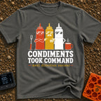 Condiments Take The Wheel - T-Shirt in Pepper - Three cartoon condiment bottles—ketchup, mustard, and mayonnaise—wearing...