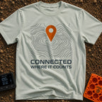 Where It Counts - T-Shirt in Bay - A graphic featuring a stylized orange map pin pointing downward onto a background of...