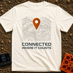 Where It Counts - T-Shirt in Ivory - A graphic featuring a stylized orange map pin pointing downward onto a background of...