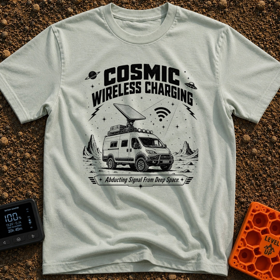 Charged By The Cosmos - T-Shirt in Bay - A black and white illustration of a rugged camper van parked on a rocky,...