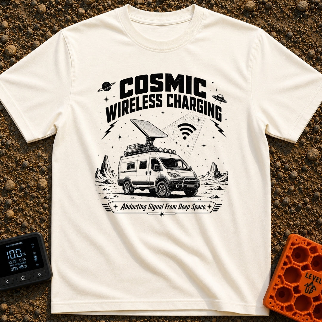Charged By The Cosmos - T-Shirt in Ivory - A black and white illustration of a rugged camper van parked on a rocky,...