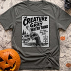 The Grey Water Creature - T-Shirt in Pepper - A black-and-white illustration of a scaly, dripping monster hand reaching...
