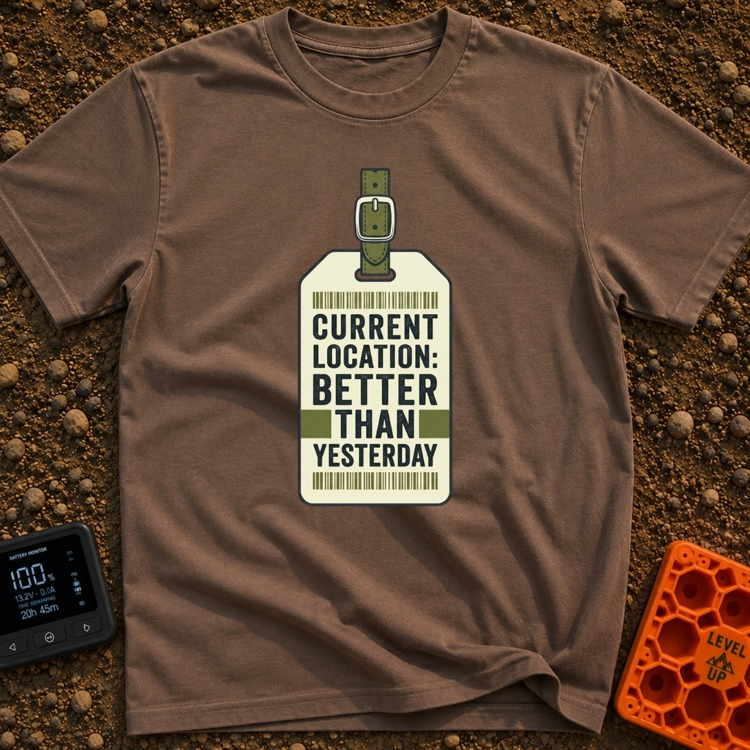 Better Than Yesterday - T-Shirt in Espresso - A graphic of a vintage-style luggage tag with an olive green buckled strap,...