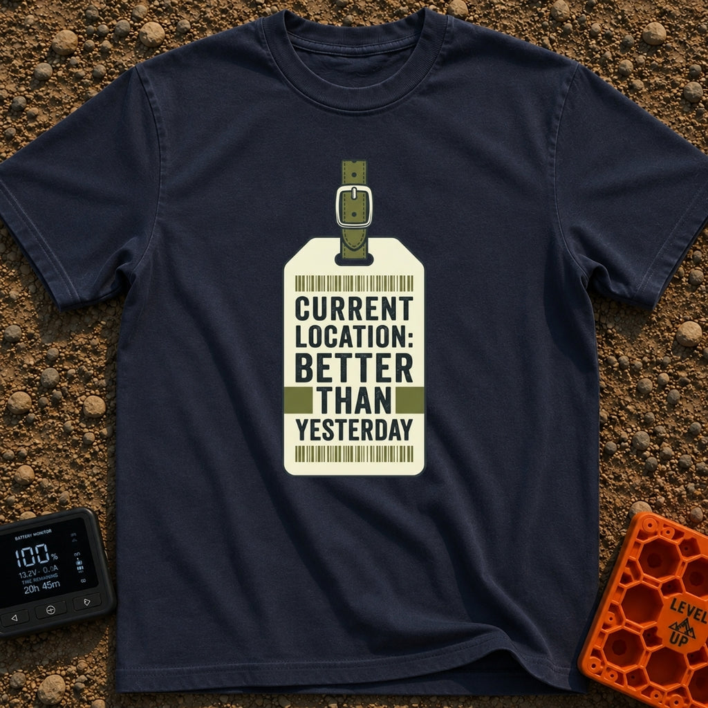 Better Than Yesterday - T-Shirt in Navy - A graphic of a vintage-style luggage tag with an olive green buckled strap,...