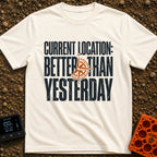 Location Better Than Yesterday - T-Shirt in Ivory - A typographic design featuring the phrase "CURRENT LOCATION: BETTER...