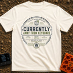 Ctrl Alt Escape - T-Shirt in Ivory - A circular, stamp-like badge design featuring the main text "CURRENTLY AWAY FROM...