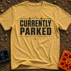 Parked Until Further Notice - T-Shirt in Mustard - A text-based design featuring the large, bold words "CURRENTLY PARKED"...