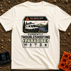 Troubleshooting In Paradise - T-Shirt in Ivory - A white camper van is parked next to a lake with mountains in the...