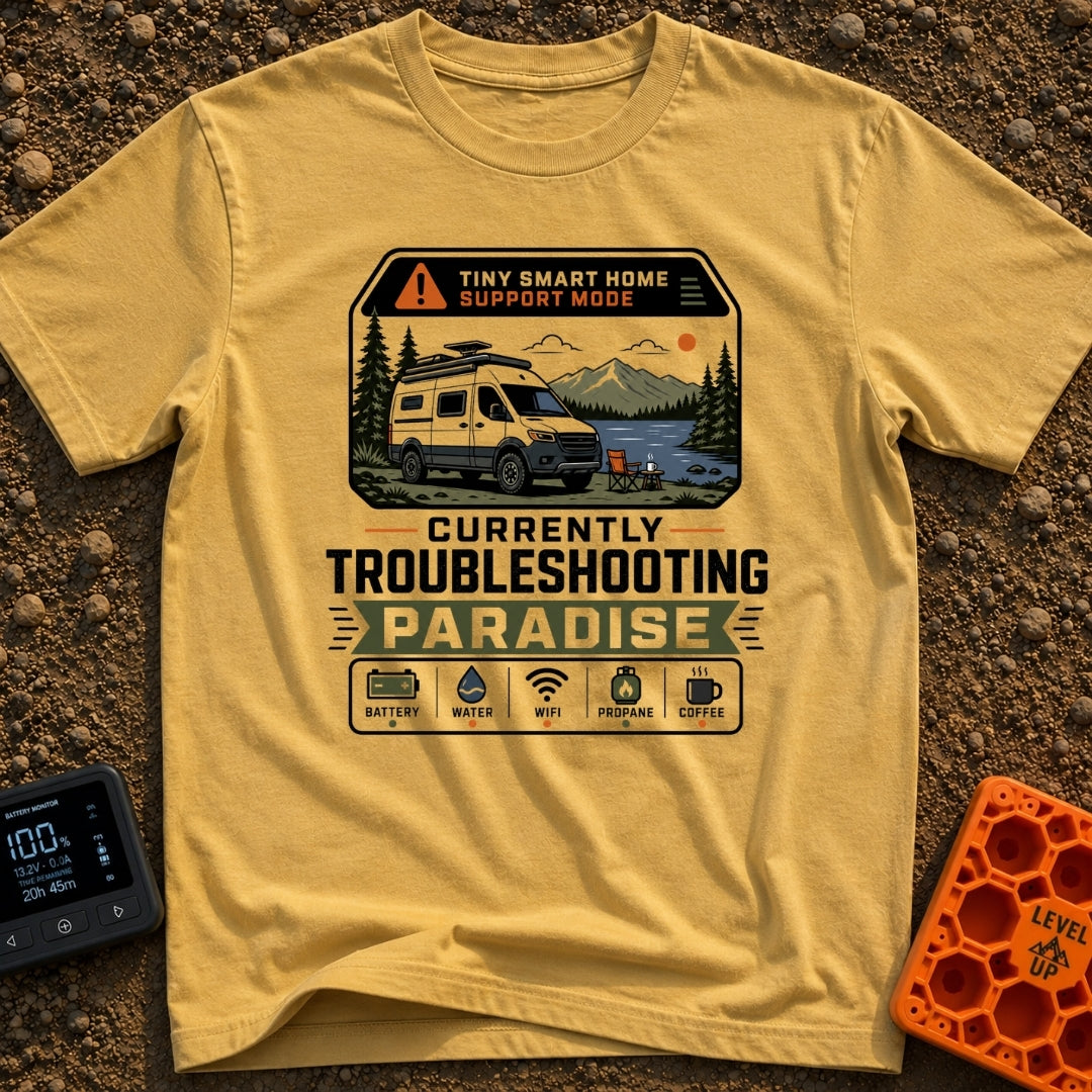 Troubleshooting In Paradise - T-Shirt in Mustard - A white camper van is parked next to a lake with mountains in the...