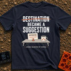 Destinations Are Suggestions - T-Shirt in Navy - A folding camp table holds a coffee mug with a mountain graphic and a...