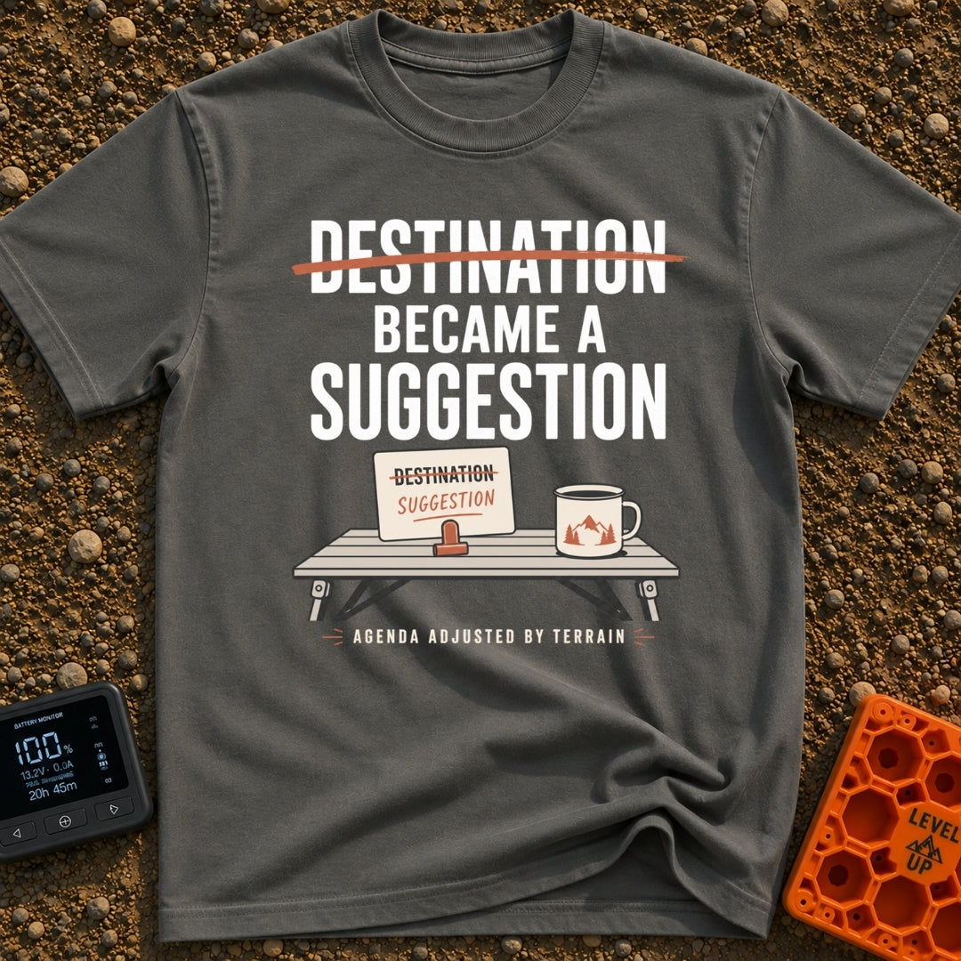 Destinations Are Suggestions - T-Shirt in Pepper - A folding camp table holds a coffee mug with a mountain graphic and a...
