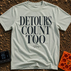 Every Detour Counts - T-Shirt in Bay - Large, stacked serif text reading "DETOURS COUNT TOO" positioned above a small,...