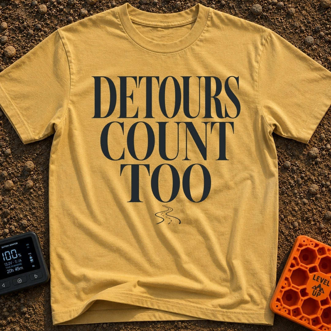 Every Detour Counts - T-Shirt in Mustard - Large, stacked serif text reading "DETOURS COUNT TOO" positioned above a...
