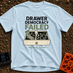 The Drawers Have Spoken - T-Shirt in Chambray - A cartoon illustration of an open wooden drawer containing an angry sock,...