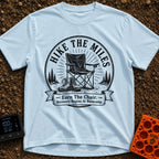 Earn Your Camp Chair - T-Shirt in Chambray - A black and white circular graphic featuring a folding camp chair and a pair...