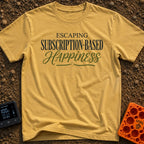 Cancel My Subscription - T-Shirt in Mustard - A text-based design reading "ESCAPING SUBSCRIPTION-BASED HAPPINESS" in a...