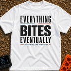 Eventually, It Bites - T-Shirt in White - A text-only design reading "EVERYTHING BITES EVENTUALLY" in bold black,...