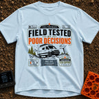 Tested By Poor Decisions - T-Shirt in Chambray - The design features a camper van parked on rocky terrain with mountains...