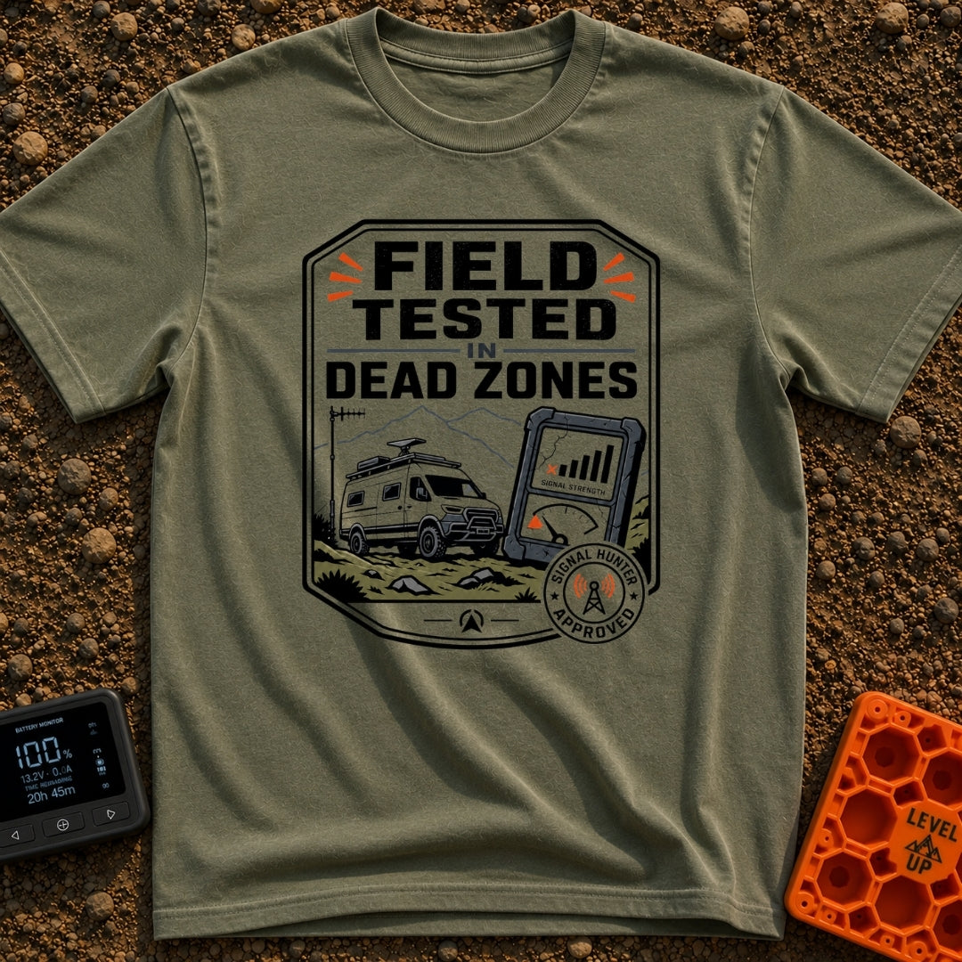 Tested In Dead Zones - T-Shirt in Moss - A badge-style illustration showing a white camper van with roof antennas parked...