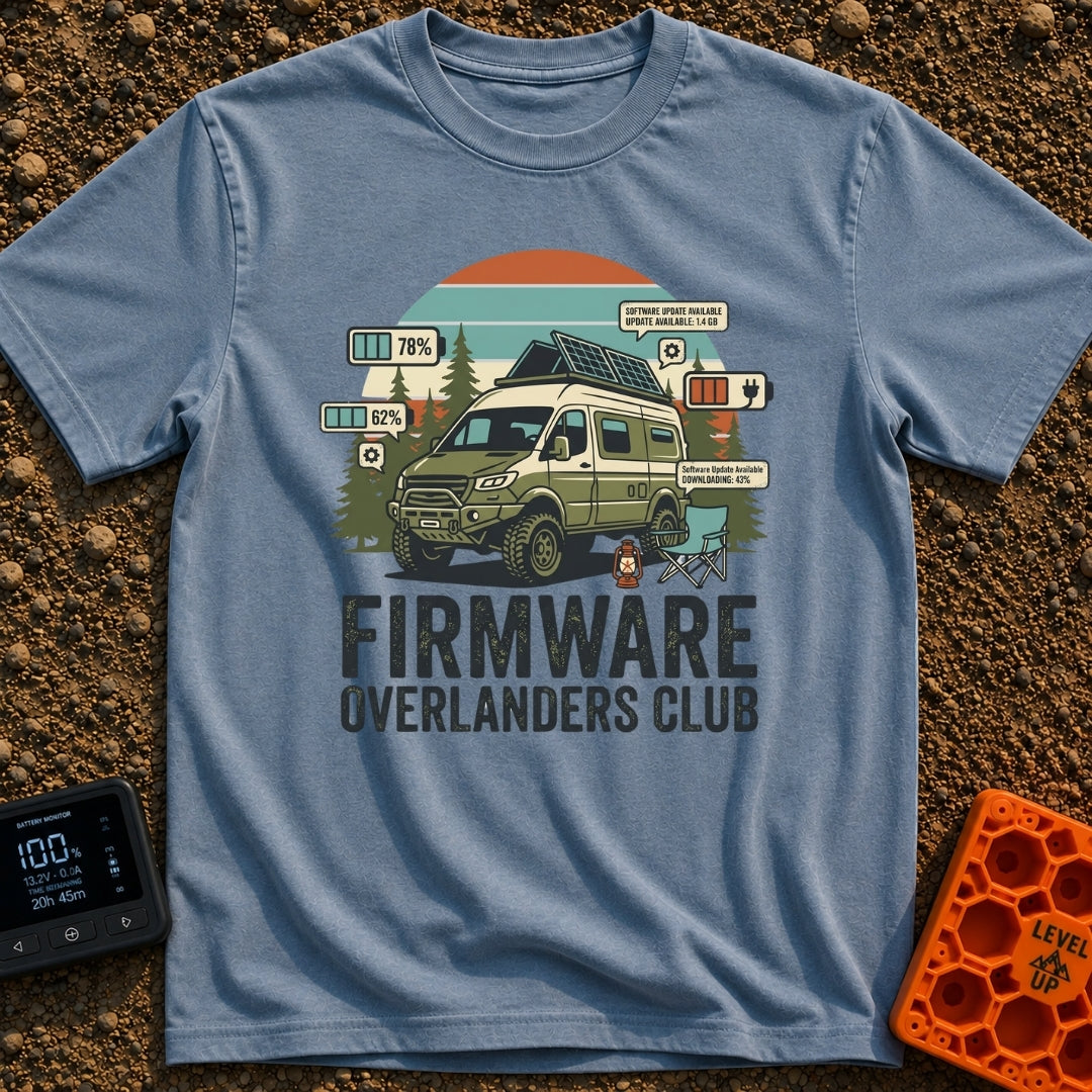 Overland Software Update - T-Shirt in Blue Jean - A rugged, off-road camper van is parked in a forest setting with a camp...