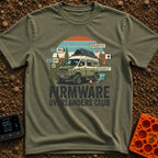 Overland Software Update - T-Shirt in Moss - A rugged, off-road camper van is parked in a forest setting with a camp...