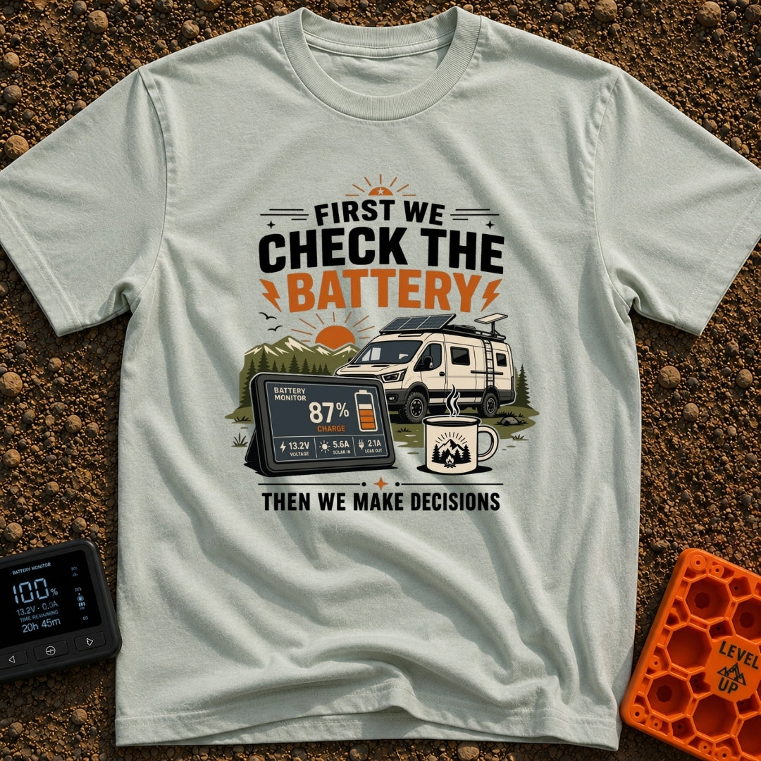 First Check The Battery - T-Shirt in Bay - A white camper van with a roof-mounted solar panel parked near mountains and a...
