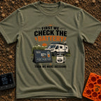 First Check The Battery - T-Shirt in Moss - A white camper van with a roof-mounted solar panel parked near mountains and...