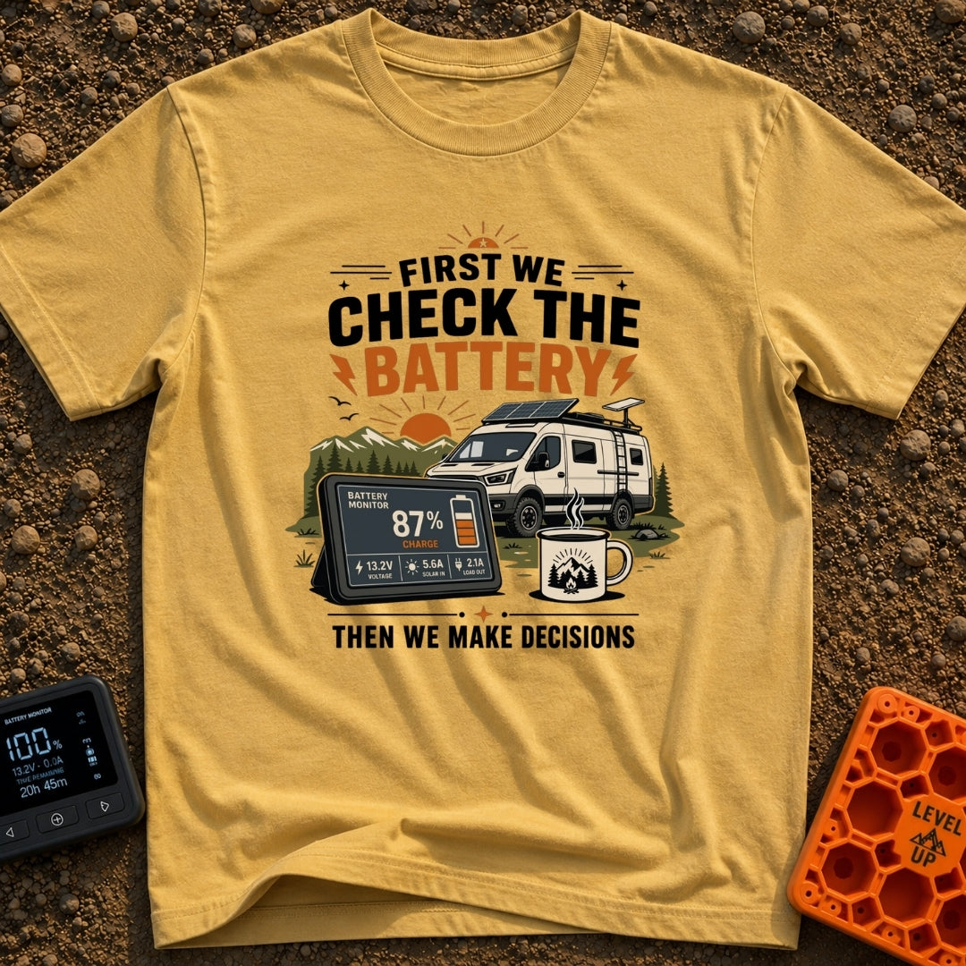 First Check The Battery - T-Shirt in Mustard - A white camper van with a roof-mounted solar panel parked near mountains...
