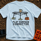 Flat Surface Club - T-Shirt in Chambray - A drawing of a foldable camp table with a green enamel mug on top, whose legs...