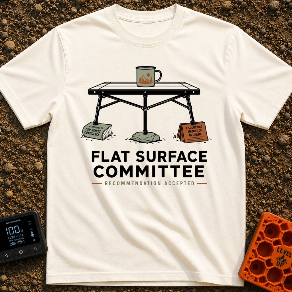Flat Surface Club - T-Shirt in Ivory - A drawing of a foldable camp table with a green enamel mug on top, whose legs are...