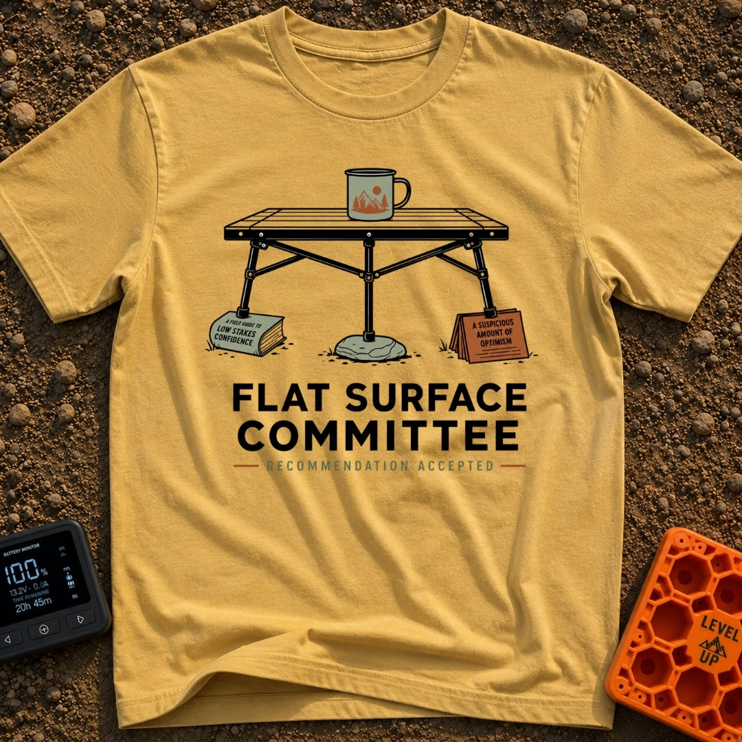 Flat Surface Club - T-Shirt in Mustard - A drawing of a foldable camp table with a green enamel mug on top, whose legs...