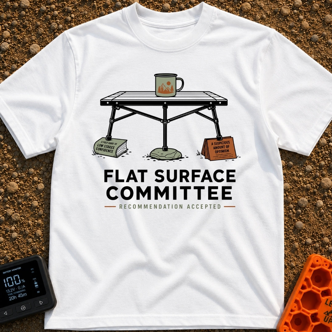 Flat Surface Club - T-Shirt in White - A drawing of a foldable camp table with a green enamel mug on top, whose legs are...